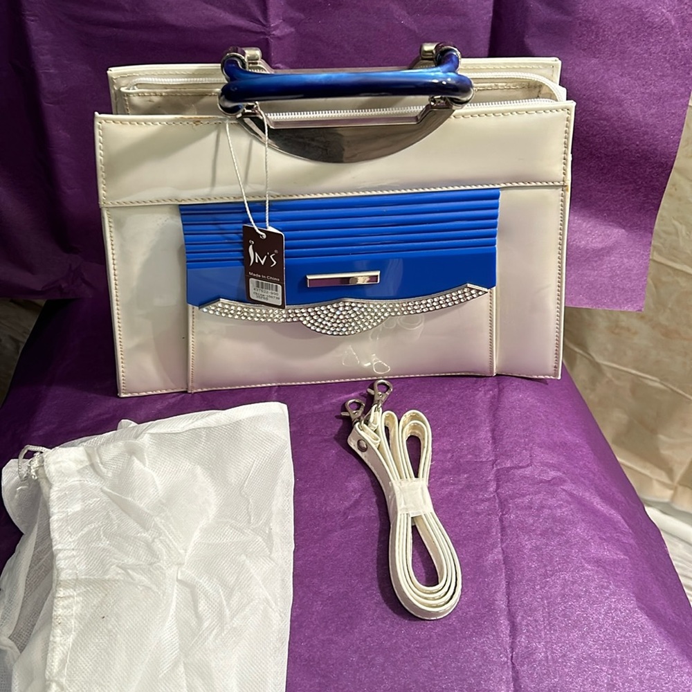 Patent leather purse with blue lucite handles and outside pocket.